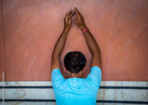 Indian man praying in a temple, Rajasthan, Jaipur, India photo