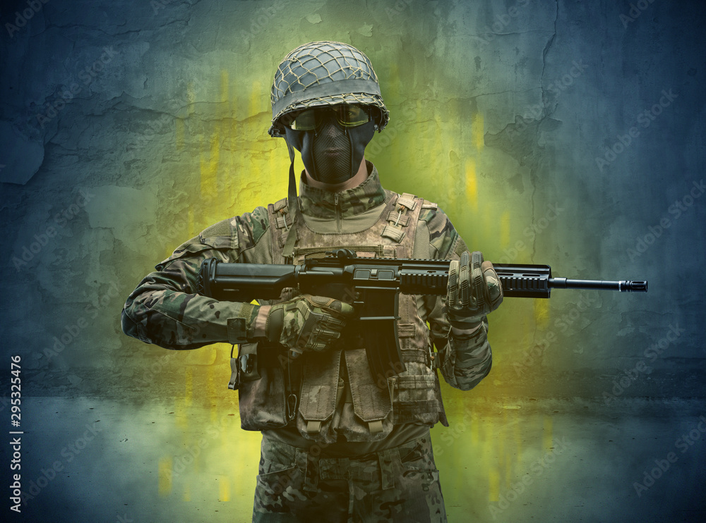 Hazard, menace soldier in a ruined crumbly building with arms on his hand Hazard, menace soldier in a ruined crumbly building with arms on his hand