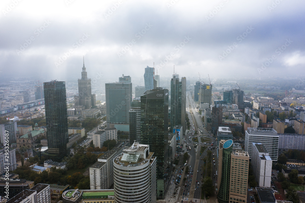 Fototapeta premium Warsaw skyline with city skyscrapers on a foggy morning. Poland. 05. October. 2019. Aerial view of the cityscape with skyscrapers and buildings in the business center of Warsaw blue sky and clouds.