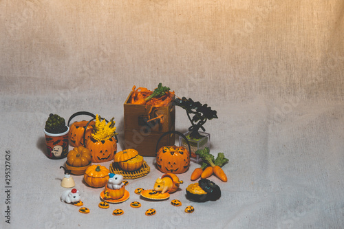halloween holiday decoration concept, A lot of halloween party object miniature toys decoration on wrinkled calico background.