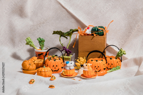 halloween holiday decoration concept, A lot of halloween party object miniature toys decoration on wrinkled calico background.
