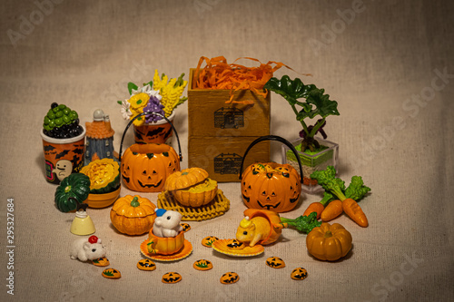 halloween holiday decoration concept, A lot of halloween party object miniature toys decoration on wrinkled calico background.