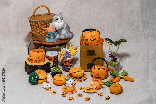 halloween holiday decoration concept, A lot of halloween party object miniature toys decoration on wrinkled calico background.