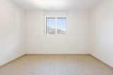 Empty room with white walls and traverti floors