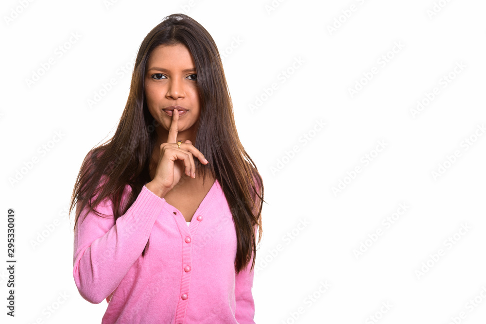 Studio shot of young beautiful Brazilian woman with finger on li Studio shot of young beautiful Brazilian woman with finger on li