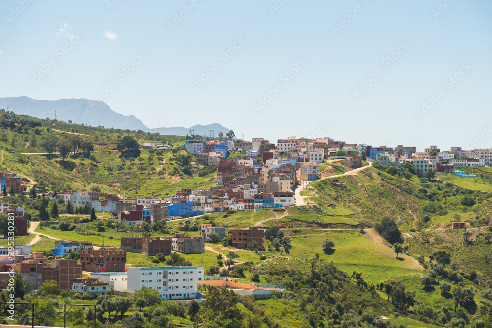 Scenic panoramic view of Chefchaouen from a hill on a sunny day, known as the blue city, Morocco