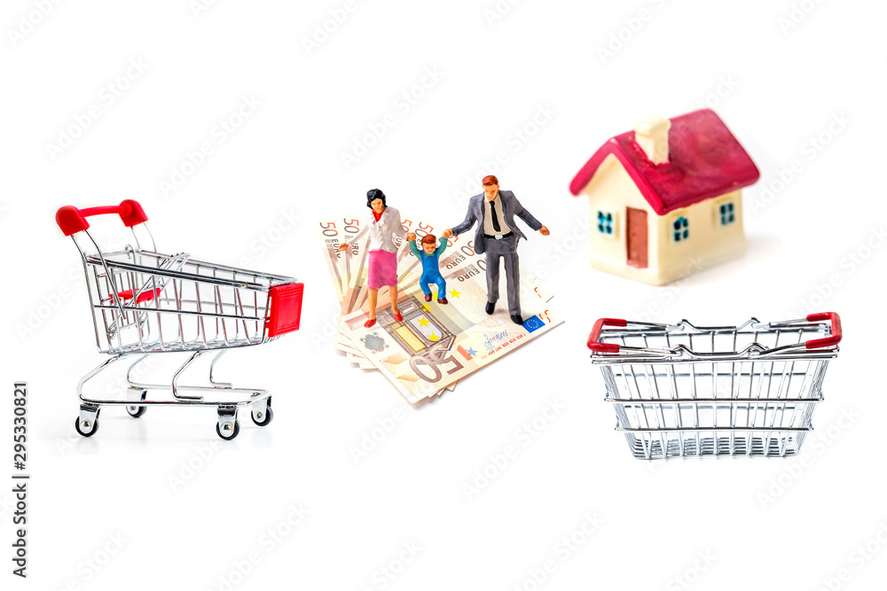 miniature family people standing on stack of 50 euro banknote with shopping cart and shopping basket isolate on white background, Image for real-estate management concept. miniature family people standing on stack of 50 euro banknote with shopping cart and shopping basket isolate on white background, Image for real-estate management concept.