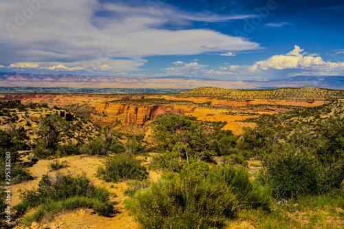 This image was captured on a very scenic trail in the Colorado National Monument near Grand Junction, Colorado. Deep canyons, rock formations, ledges, and plateaus are seen.