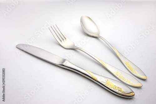 fork and spoon lay on white background