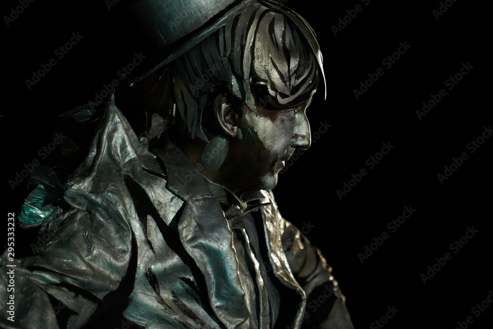 Side view of mime actor with facial makeup looks like statue Side view of mime actor with facial makeup looks like statue