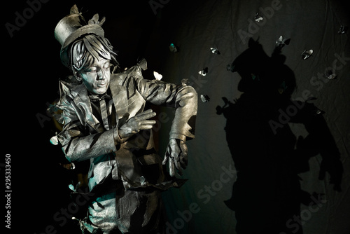 Portrait of mime artist performing art on black background