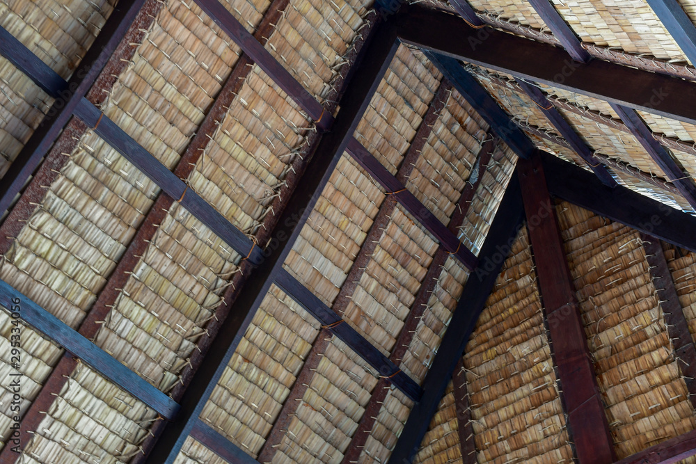 Traditional swiss thatch roof from the inside. Piece of a tap thatching that made from strips of Nipa leaves, nature leafs texture background.