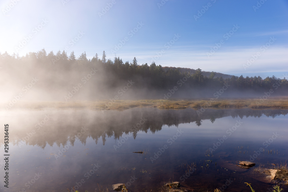 Lake in Algonquin national park ontario canada with foggy mystical atmosphere