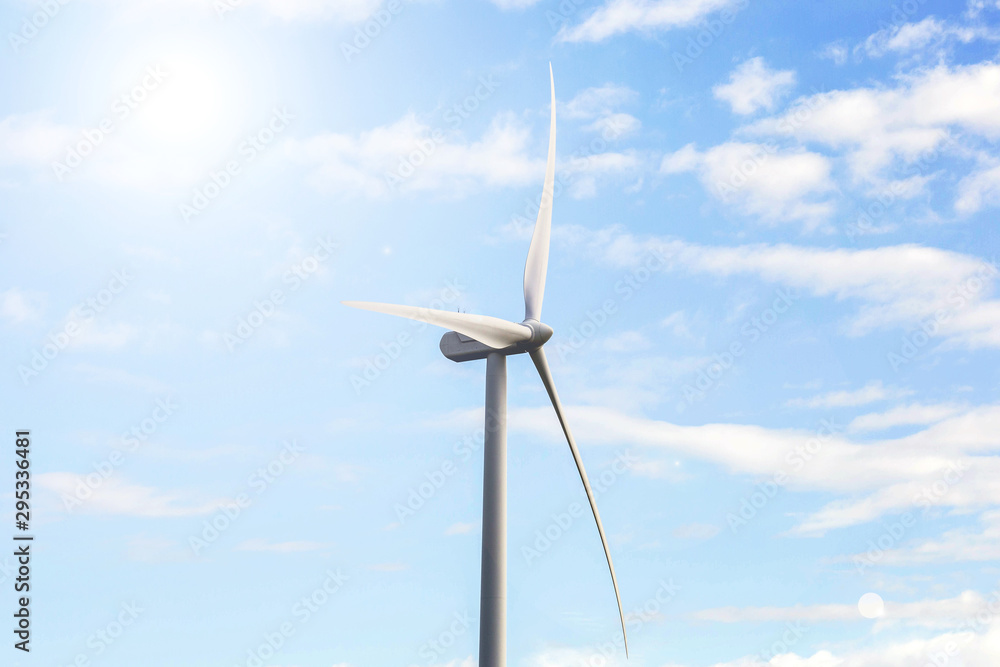 modern windmill on a sunny day and with idyllic moody clouds, closeup of the foreground, Energy concept sunlight