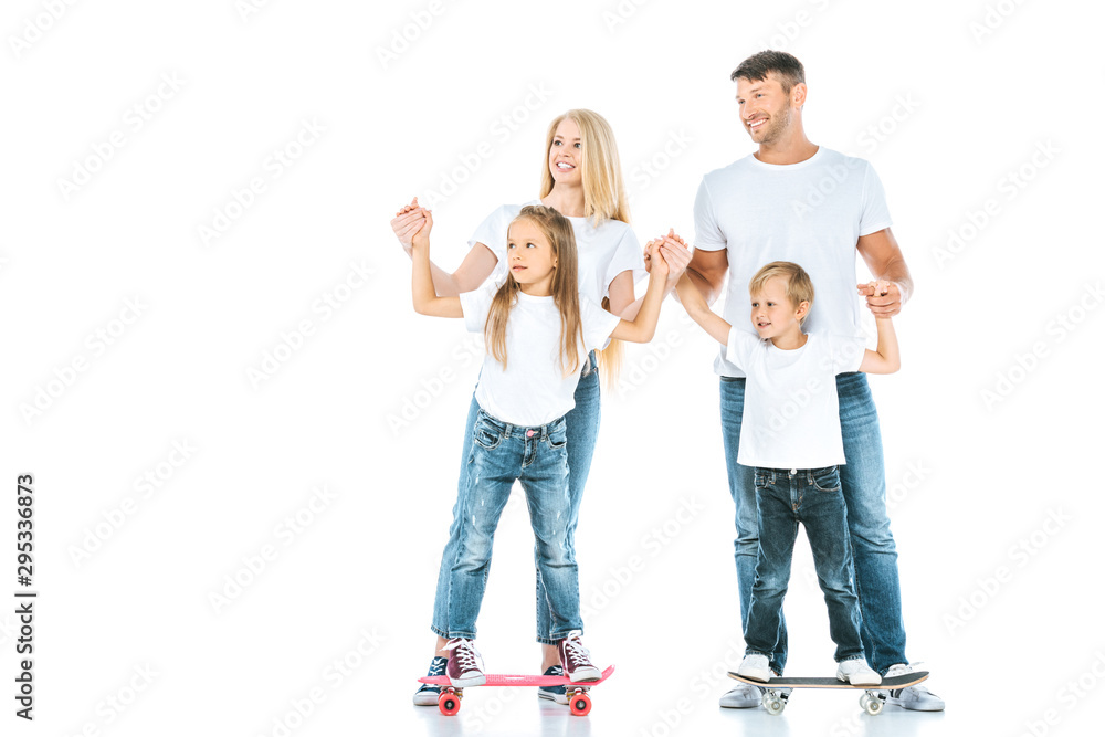 happy parents near holding hands of children riding penny boards on white happy parents near holding hands of children riding penny boards on white