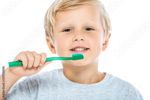 cute and happy boy holding toothbrush isolated on white