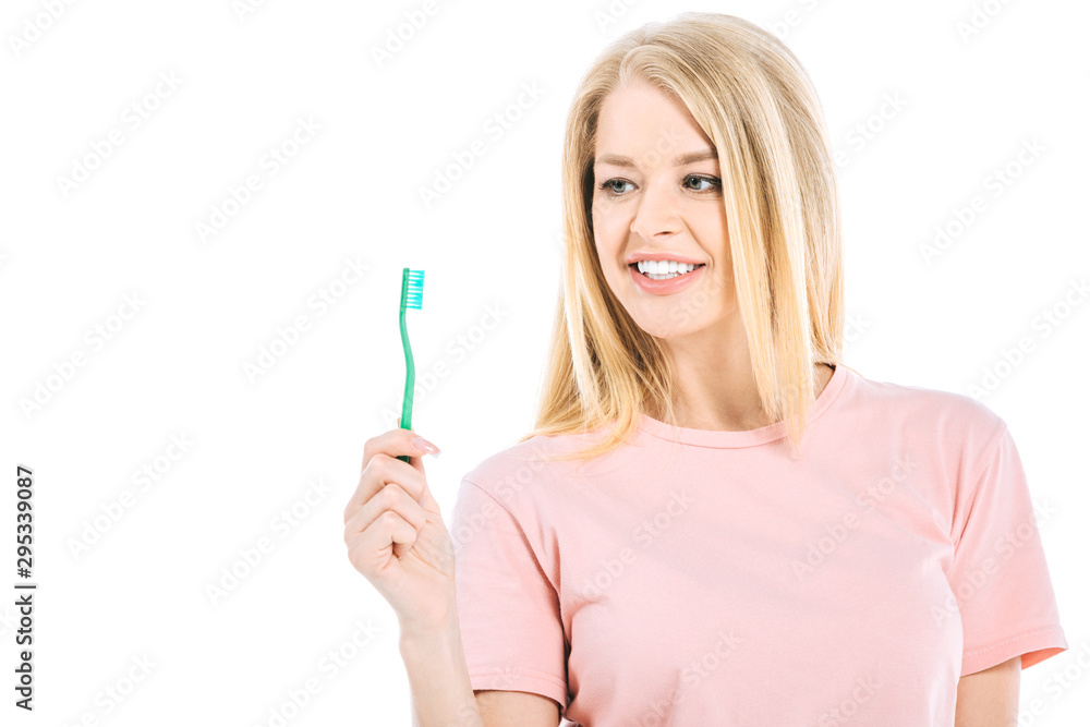 beautiful woman looking at tooth brush isolated on white beautiful woman looking at tooth brush isolated on white