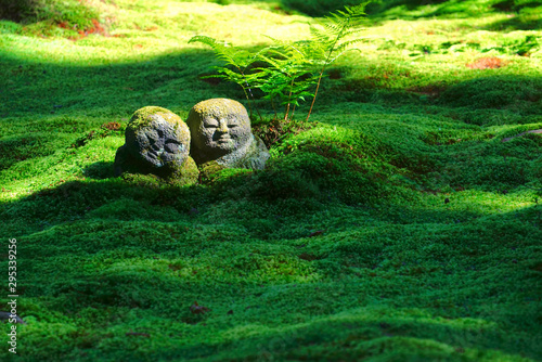 The moss garden and stone statues in the Sanzenin temple, Ohara, Kyoto, Japan photo