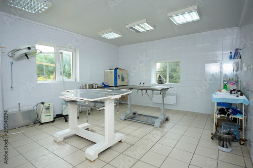 Med table, lamps and other medical equipment set  at the veterinary office photo