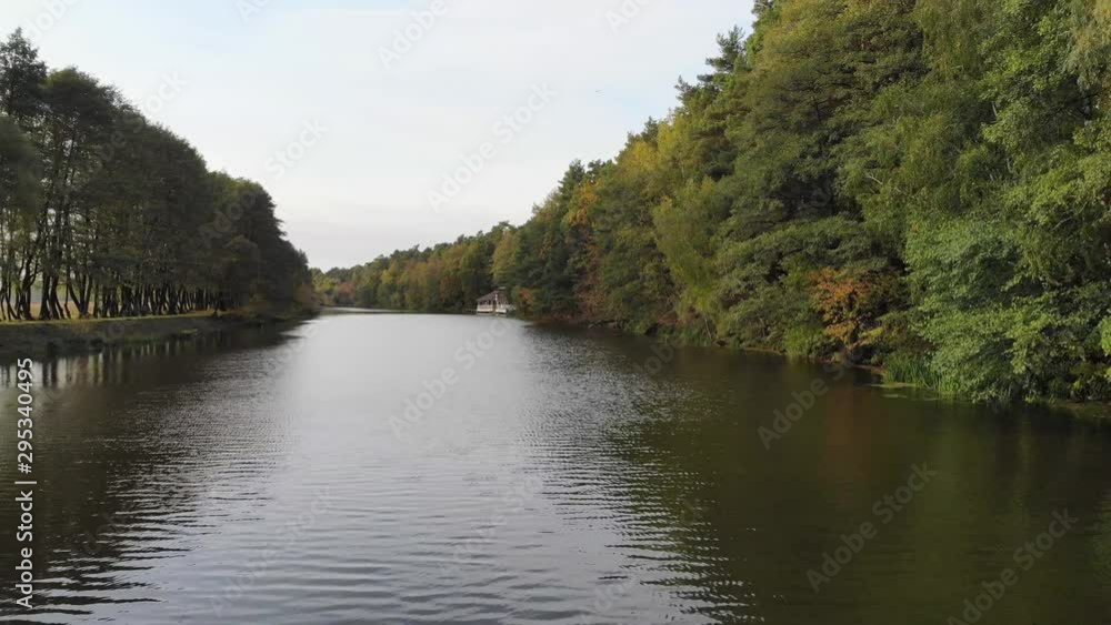 Flight over the forest river. Autumn nature. House by the river. Flight over the forest river. Autumn nature. House by the river.