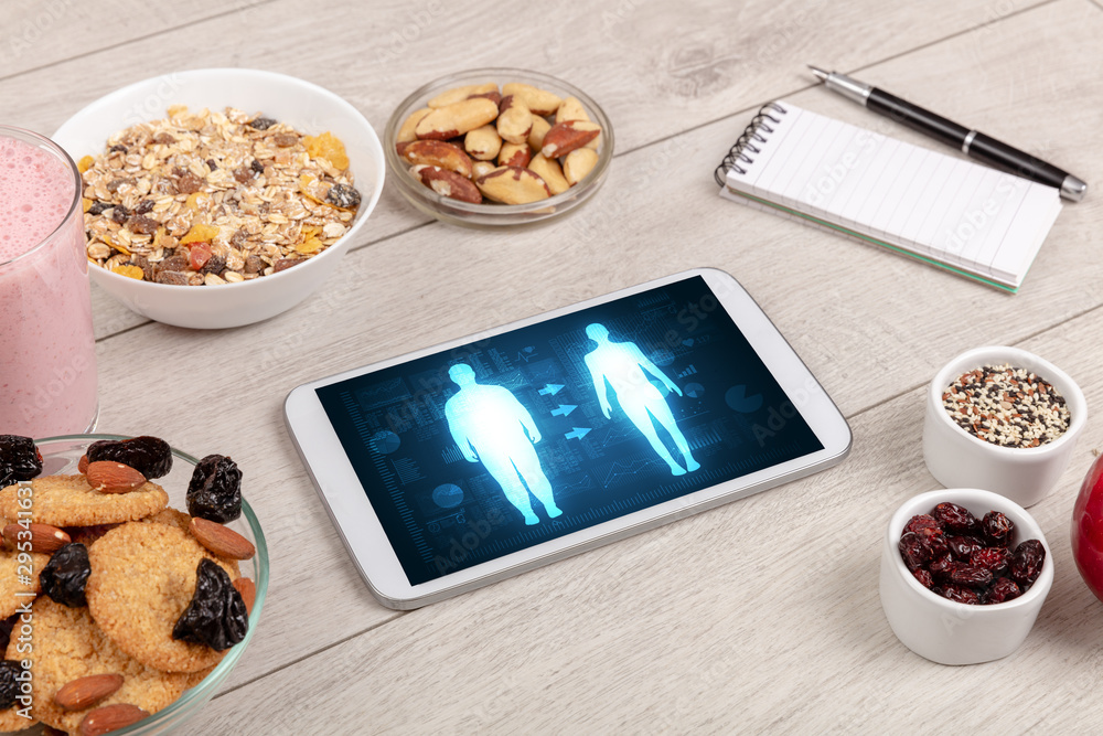 Arrangement of healthy Ingredients with a tablet. Dieting concept Arrangement of healthy Ingredients with a tablet. Dieting concept