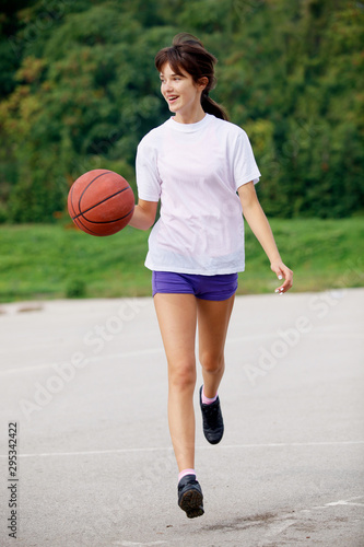 teenage girl scoring during basketball game in school court sport