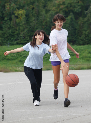 teenage girl scoring during basketball game in school court sport