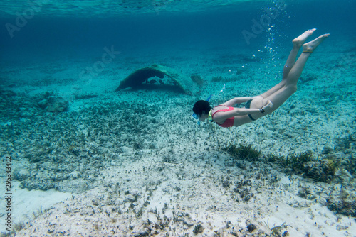 snorkel girl swimmin at the blue sea