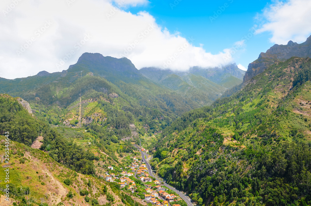 Stunning view of picturesque village Serra de Aqua in Madeira Island, Portugal. Small city in a valley surrounded by green mountains. Portuguese landscape. Amazing travel destinations