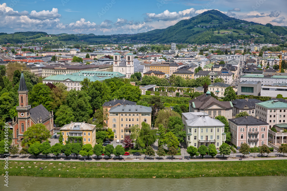 Naklejka premium Panoramic view of Salzach river and the garden in Schloßpark Mirabell in Salzburg with Barockmuseum and church St. Andrä, Austria