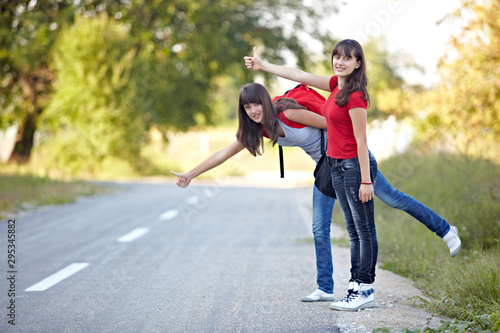 beautiful teenage girl hitchhike on empty road travel adventure © Lumos sp