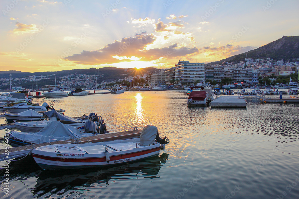 Sailing boats in the harbor of City of Drama in Greece at Sunset