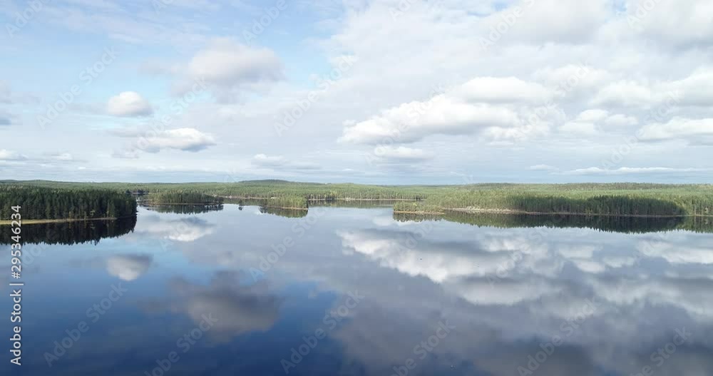 Aerial View. Flying over the beautiful lake. Blue sky and clouds. Aerial camera shot. Finland. Aerial View. Flying over the beautiful lake. Blue sky and clouds. Aerial camera shot. Finland.