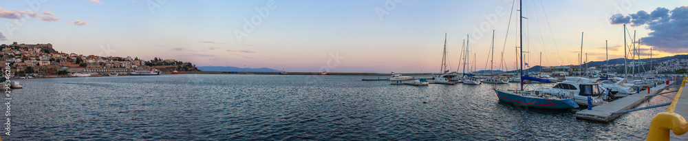 Panoramic of the Mediterranean Sea with Sailing boats in the harbor of City of Drama in Greece at Sunset