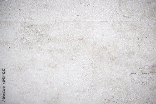 Light surface of concrete. The surface is uneven, with traces of construction tools. The color is light gray. Horizontal orientation.