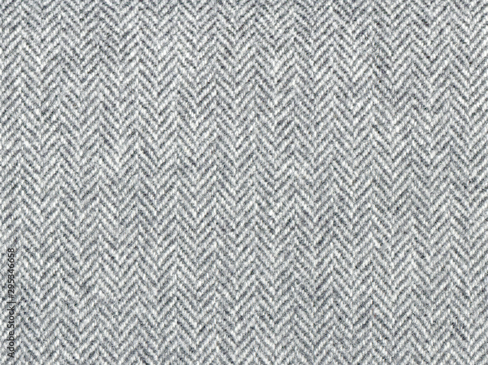 Elegant classic grey woolen fabric. Herringbone tweed, Wool Background Texture. Coat close-up. Expensive men's suit fabric. High resolution Elegant classic grey woolen fabric. Herringbone tweed, Wool Background Texture. Coat close-up. Expensive men's suit fabric. High resolution