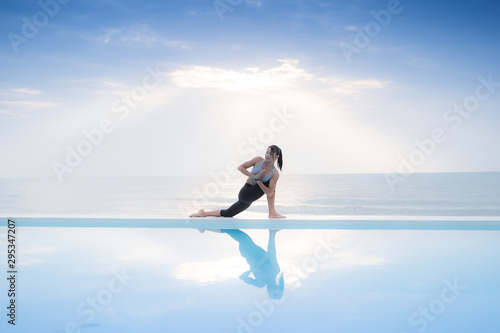 Asian woman practice yoga on the beach