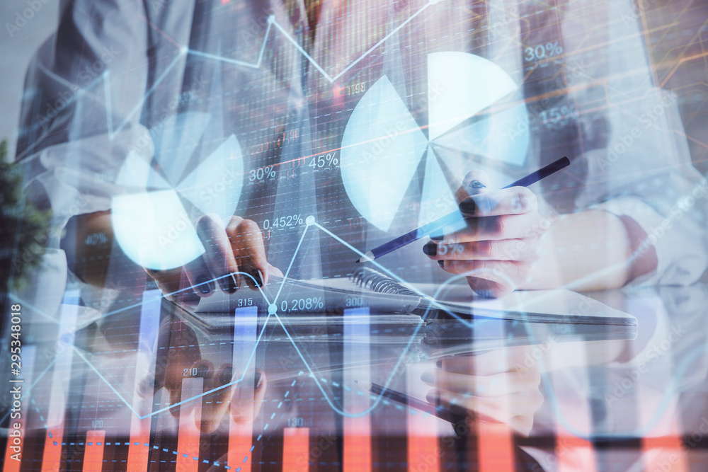 Financial forex graph drawn over hands taking notes background. Concept of research. Double exposure Financial forex graph drawn over hands taking notes background. Concept of research. Double exposure