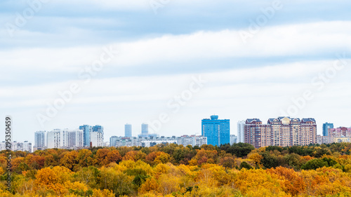 Photography cloudy sky over city and yellow park in autumn