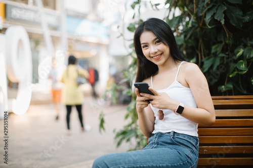 young woman using smart phone outdoors