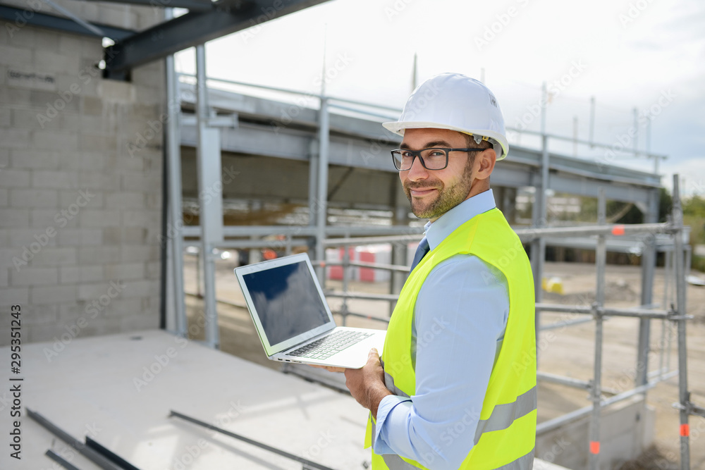portrait of handsome foreman construction worker on a industrial building industry construction site portrait of handsome foreman construction worker on a industrial building industry construction site