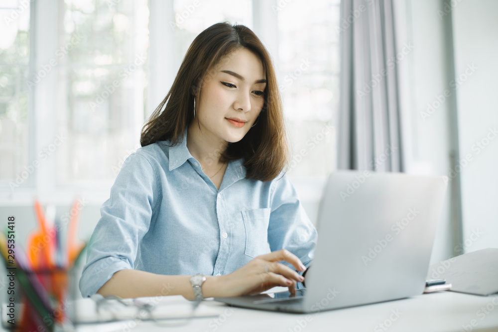 businesswoman working on laptop in her workstation businesswoman working on laptop in her workstation