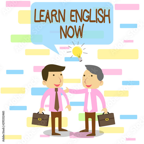 Writing note showing Learn English Now. Business concept for gain or acquire knowledge and skill of english language Two White Businessmen Colleagues with Brief Cases Sharing Idea Solution