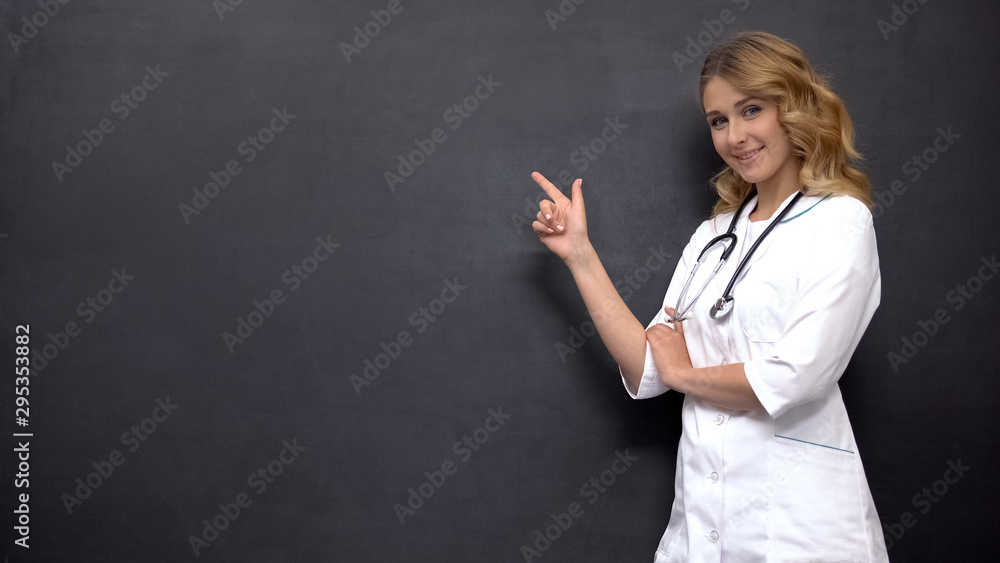Female doctor pointing at place on blackboard, template for medical prescription Female doctor pointing at place on blackboard, template for medical prescription
