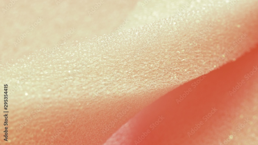 Fototapeta premium White pink artificial foam, soft texture on a light background.