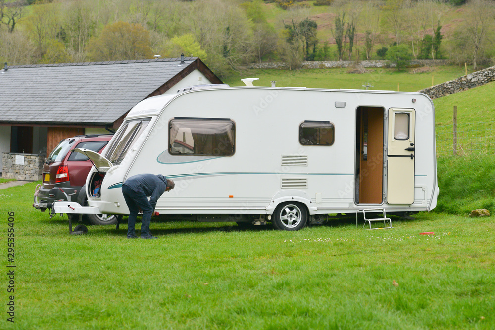 Setting up a caravan on camp site in rural Wales. Setting up a caravan on camp site in rural Wales.