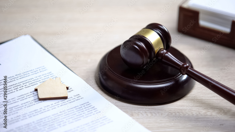 Wooden house sign on document, gavel lying on sound block, property law