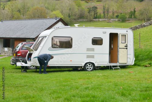 Setting up a caravan on camp site in rural Wales.
