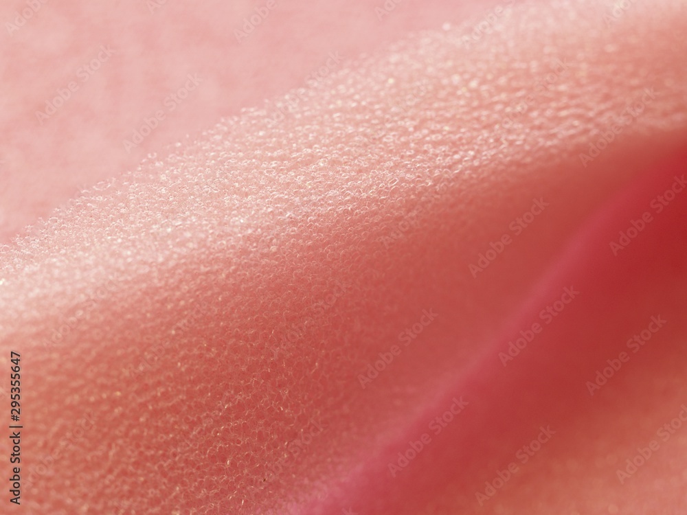 Fototapeta premium White pink artificial foam, soft texture on a light background.