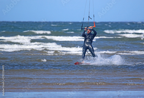 kitesurfer riding his board